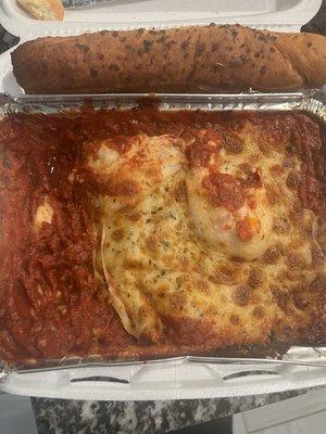 undercooked Lasagna with Italian Sausage with no ricotta cheese, no italian sausage and no noodles just raw sauce and burnt Bread Sticks