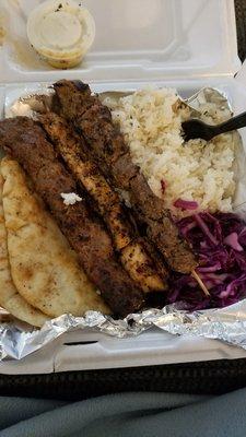 Mixed grill platter with pita, rice and cabbage salad.