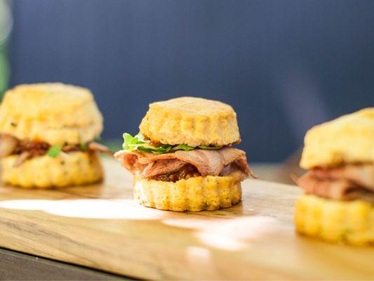 Lamb brisket on chive biscuit with peaches and young greens