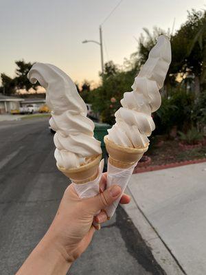 Two vanilla soft serve ice cream cones