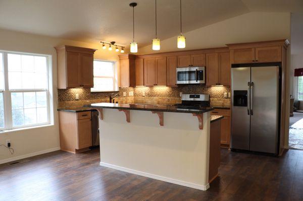 New island, lighting, flooring, cabinets, and countertops