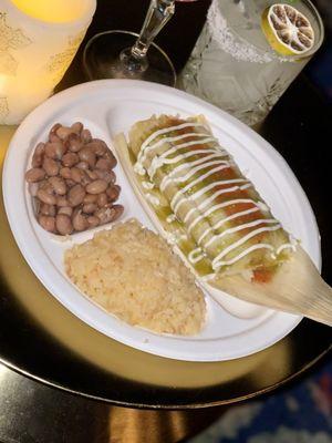 Tamale late special topped with green salsa, red salsa, whipped cream