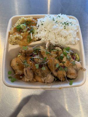 Braised Chicken Thighs, vegetables, white rice, and garlic confit mashed potatoes.