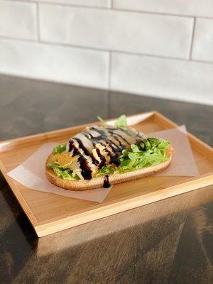 Avocado toast - avocado, arugula, fried egg and balsamic drizzle