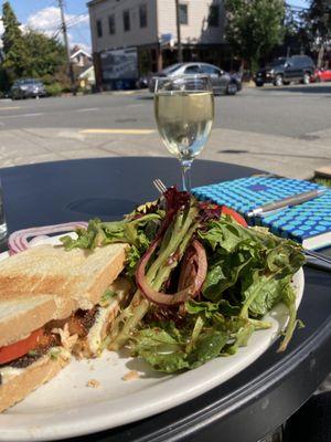 Yummy blackened salmon sandwich with green salad.