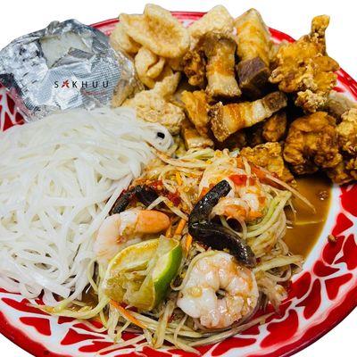 tum thadd - a platter full of Lao papaya salad, crispy pork belly, crispy chicken, pork rinds, sticky rice and steamed noodles!