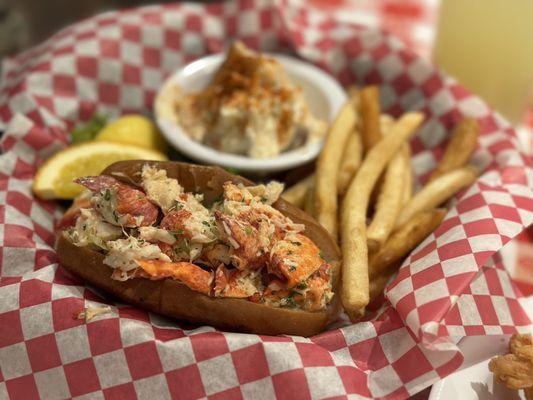 Lobster roll with potato salad and fries