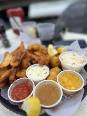 Delicious dolphin fingers Mahi Mahi and coconut shrimp with slaw. . Service is great. Fresh seafood.