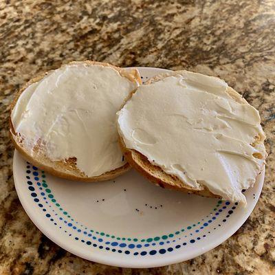 An everything bagel cut just right from Jeffs Bagel Run with cream cheese.