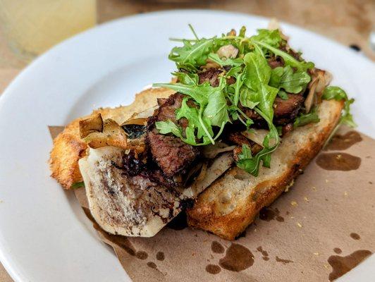 February 19, 2023; Bone marrow with beef short ribs, mushrooms, sourdough crostino ($24).