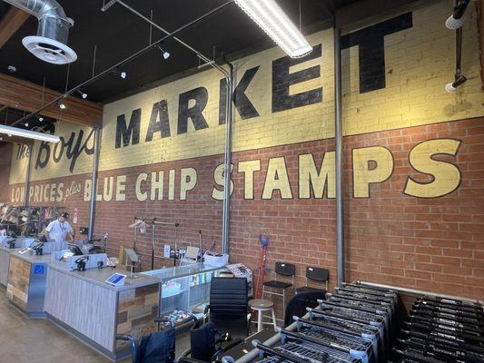 Historical painted signage on brick. "The Boys Market" "low prices plus blue chip stamps".