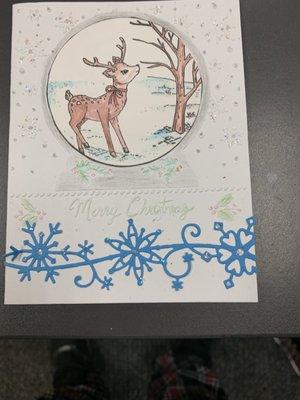 A Christmas card that combines color pencils with a die cut and embossed design.