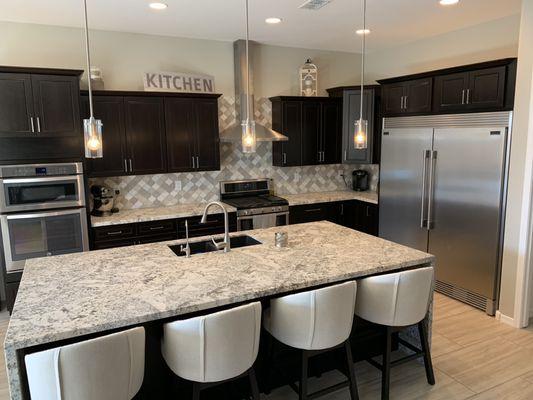 New counters, backsplash, flooring and a happy homeowner.