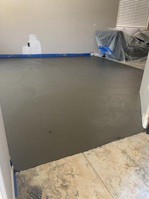 Fresh concrete to raise the floor in a sunken room.