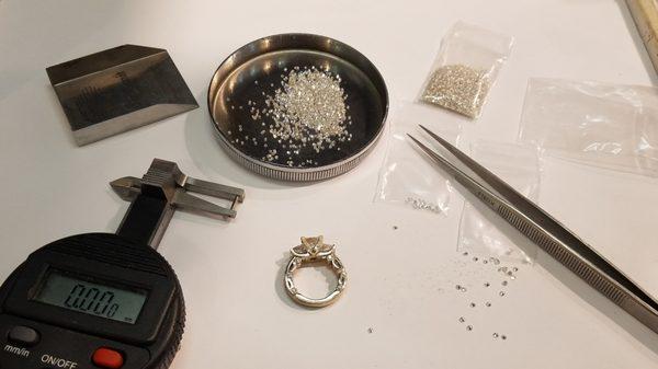 selecting the diamonds to accent the ring.