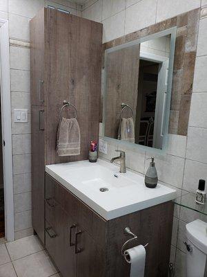 Custom made vanity and bathroom pantry with LED mirror