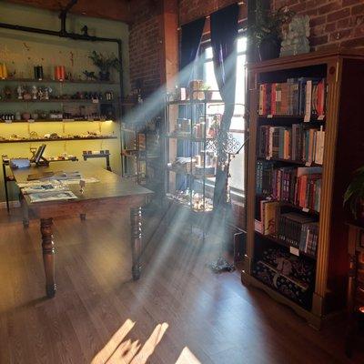 Magic shop with books, crystals, candles, prints, resins, incense, altar items, and tools.