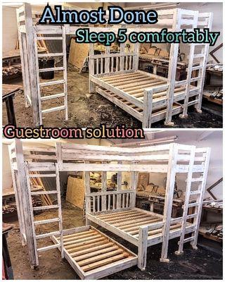 Custom bunk bed with trundle bed under the queen bed and an attached fold down desk on the side