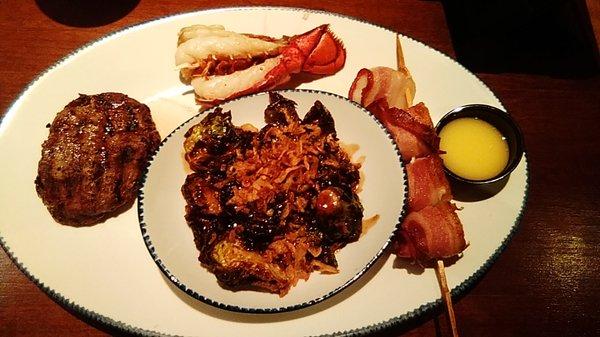 Strips of lobster the top, to the right are the bacon wrapped scallops, butter sauce. left, the "filet". In the middle, brussel sprouts