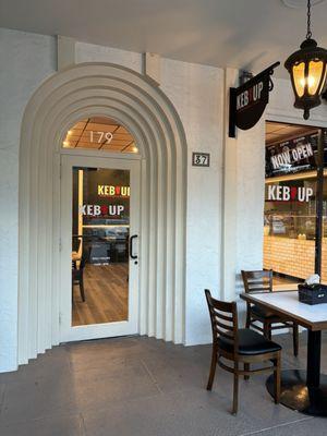 Cool entrance doorway with outside covered tables.