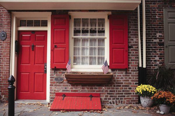 charming trinity facade on elfreth's alley with red shutters and bilco