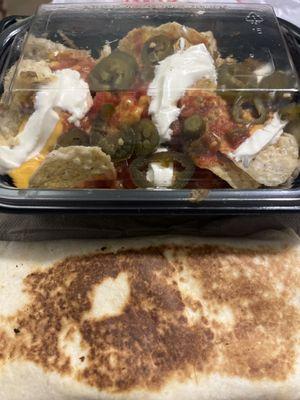 A chicken quesadilla, very flat, very small, too small Beef nachos