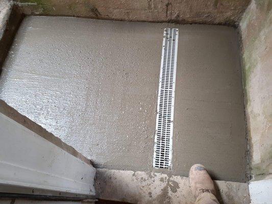 Freshly Laid Concrete and Grate Speed Drain