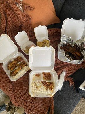 Fried chicken and pork chop with white rice and beans. Also, fried plantains