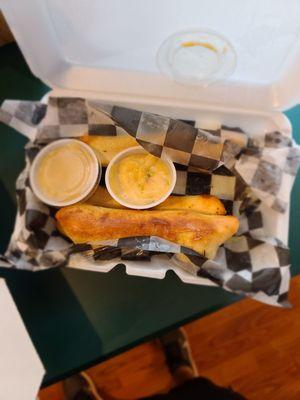 Garlic Parmesan breadsticks with nacho cheese on the side