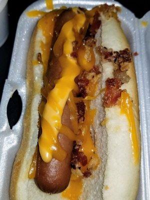 Loaded dog. Chili, cheese, potato puff, bacon, crispy onions