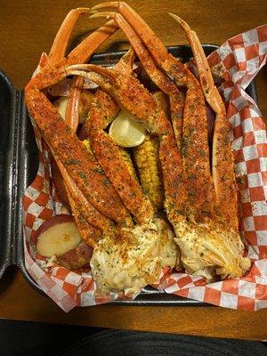 Crab legs, sausages, potatoes, and corn