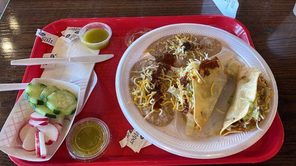 Two shredded beef, tacos, and extra beans instead of rice and the green sauce is wonderful.