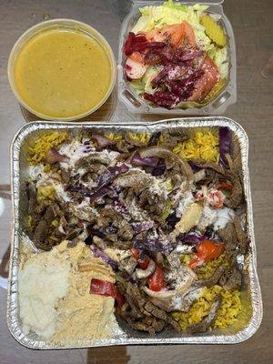 Take out Lamb Shawarma Plate -- comes with soup or salad. Loaded with rice underneath and a dolmada. Lots of very flavorful lamb on top.