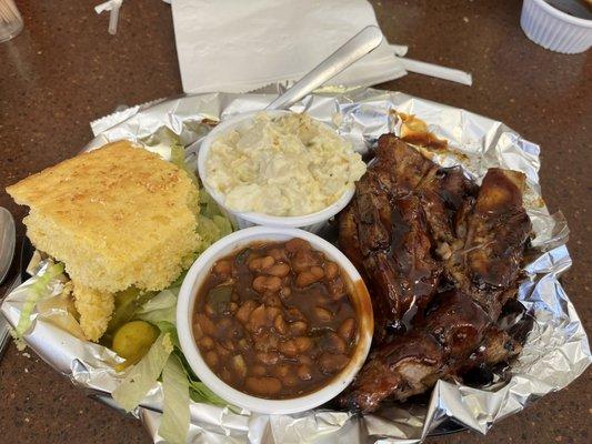 Tender pork ribs, cornbread & sides of beans & potato salad.