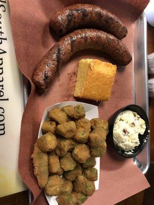 2 piece smoked sausage with fried okra and potato salad.