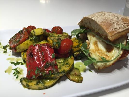 Half of my turkey, jack, fried egg breakfast sandwich with roasted vegetable salad