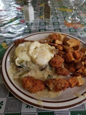 .  Eggplant with two poached eggs cover in a new Orleans sauce surrounded by fried oysters and home fries