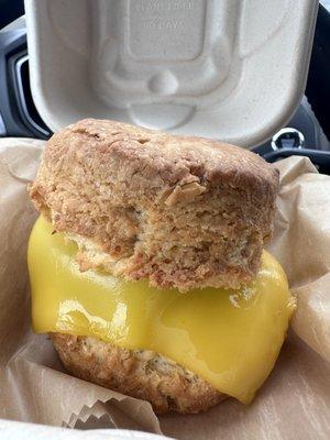 Vegan cheddar & garlic biscuit with cheese and sausage patty.