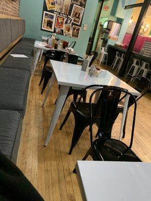 4 tables in the back (one large table up front, the rest of the seating is tall metal bar stools)