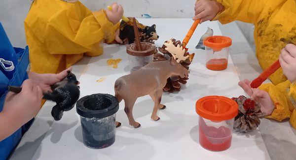 Woodland Animals theme: Children paint woodland animals and pine cones using fall colors