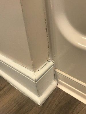 Wall against tub