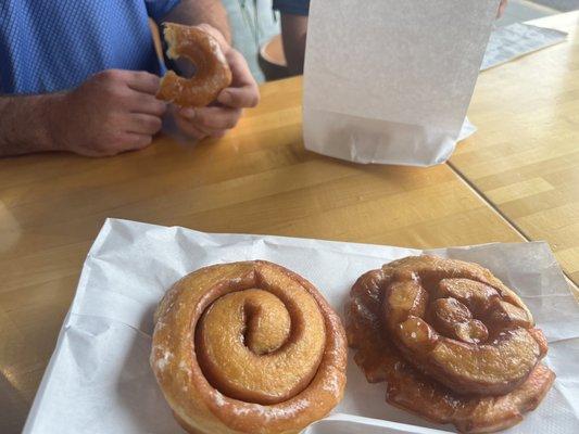 Cinnamon roll on the left and the raspberry roll on the right. Glazed also pictured.