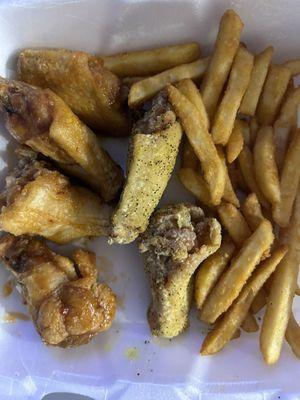 Mango habanero and lemon pepper wings with crispy yet soft centered fries.