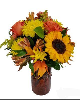 Fall shades of yellow and orange using alstromeria, sunflowers, chrysanthemums, and solidago.