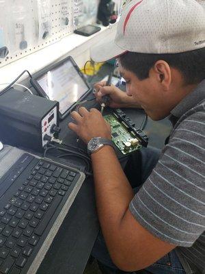 We offer keys for luxury vehicles. Our tech Joe working in the lab on a BMW module.