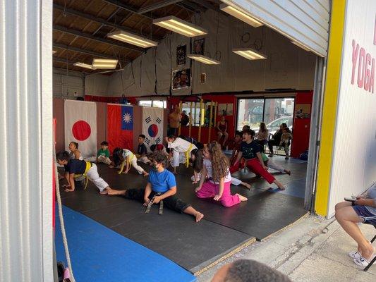 The kids are doing stretches before boxing start.