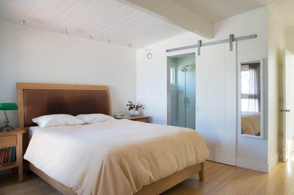 Bathroom door in tight space is made both functional and beautiful with sliding barn door hardware.