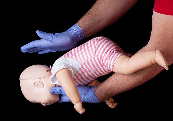 Exhibiting the process of CPR with infants on a mannequin.