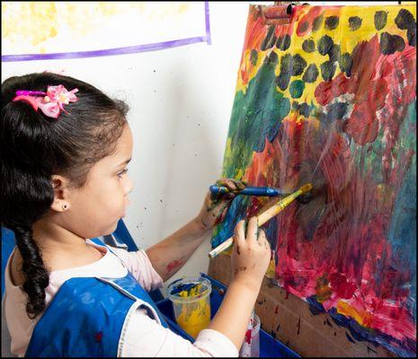 Girl painting at easel