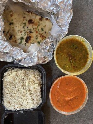 Butter chicken with basmati rice, garlic naan, and yellow daal...